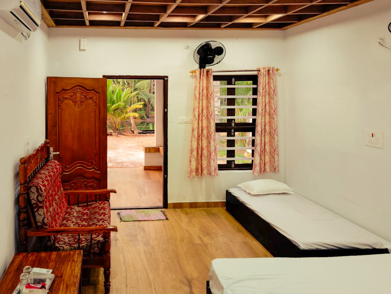 Cozy air-conditioned bedroom interior at Mundro's Haven's homestay